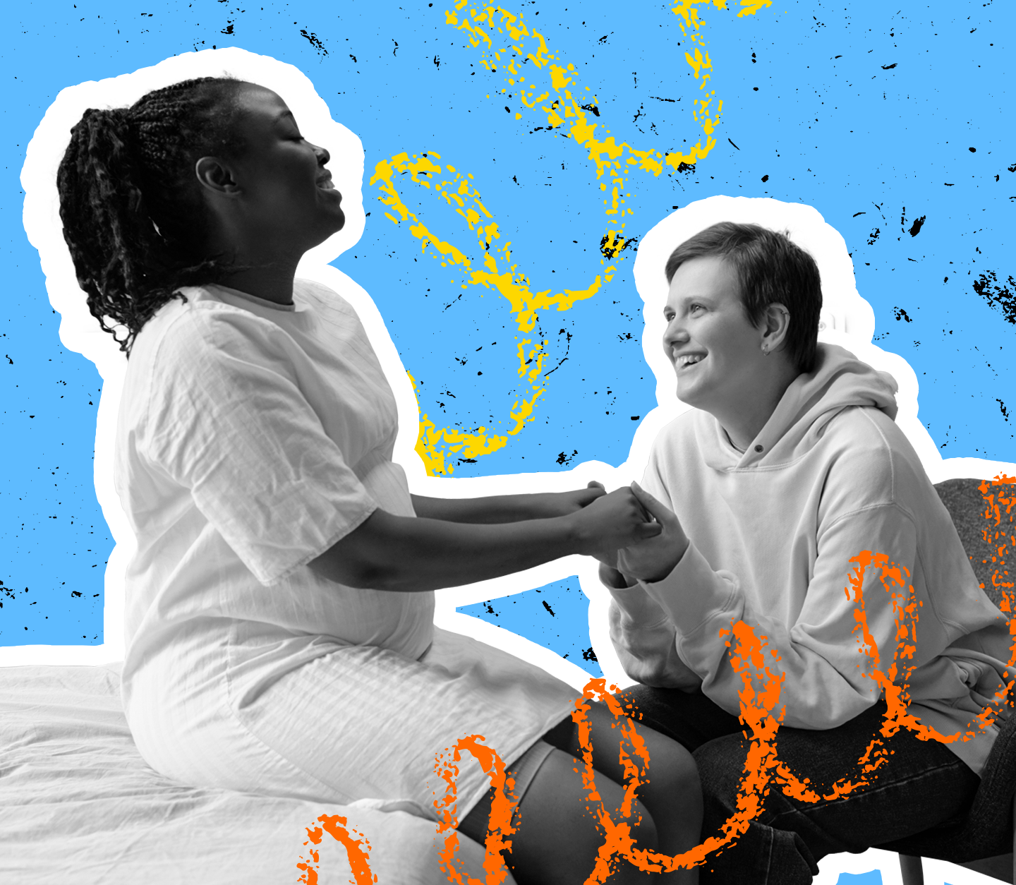 A person sits on a bed, holding hands with a friend, they are both laughing