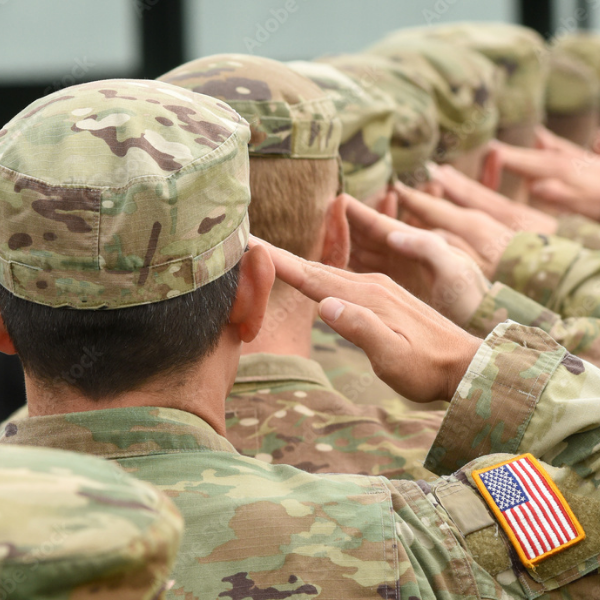 Military members from behind saluting.